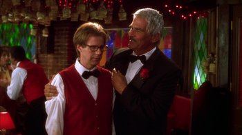 Movie still from “The Master of Disguise” (2002), directed by Perry Andelin Blake – A man in a suit and a man in a tie; Medium shot, Over the shoulder angle