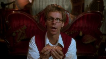 Movie still from “The Master of Disguise” (2002), directed by Perry Andelin Blake – A man holding a doughnut in his hands; Close Up shot, Overhead angle