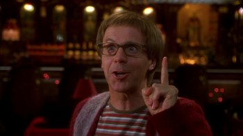 Movie still from “The Master of Disguise” (2002), directed by Perry Andelin Blake – A man in a striped t - shirt is pointing up; Close Up shot, Over the shoulder angle