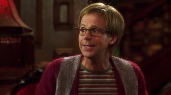 Movie still from “The Master of Disguise” (2002), directed by Perry Andelin Blake – A man wearing a striped shirt and a furry vest; Close Up shot, Over the shoulder angle