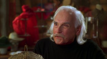 Movie still from “The Master of Disguise” (2002), directed by Perry Andelin Blake – An older man with white hair looking at the camera; Close Up shot, Over the shoulder angle
