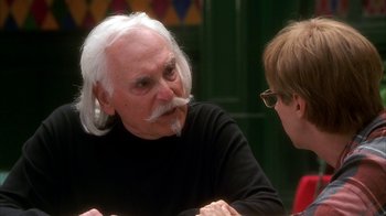 Movie still from “The Master of Disguise” (2002), directed by Perry Andelin Blake – An older man with a long white beard talking to a younger woman; Close Up shot, Over the shoulder angle