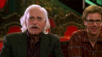 Movie still from “The Master of Disguise” (2002), directed by Perry Andelin Blake – An old man with a long white beard and glasses; Close Up shot, Over the shoulder angle