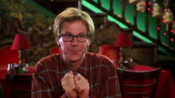Movie still from “The Master of Disguise” (2002), directed by Perry Andelin Blake – A man in a red and black shirt is smiling; Close Up shot, Low angle