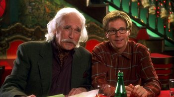 Movie still from “The Master of Disguise” (2002), directed by Perry Andelin Blake – Two men sitting at a table with a bottle of wine; Close Up shot, Low angle