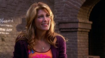 Movie still from “The Master of Disguise” (2002), directed by Perry Andelin Blake – A beautiful woman with long blonde hair wearing a pink shirt; Close Up shot, Over the shoulder angle