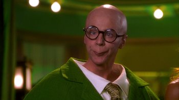 Movie still from “The Master of Disguise” (2002), directed by Perry Andelin Blake – A bald man wearing a green jacket and glasses; Close Up shot, Low angle