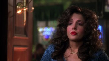 Movie still from “The Master of Disguise” (2002), directed by Perry Andelin Blake – A person with long curly hair; Close Up shot, Over the shoulder angle