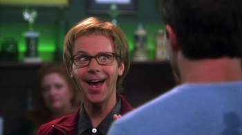 Movie still from “The Master of Disguise” (2002), directed by Perry Andelin Blake – A man with glasses is laughing at a party; Close Up shot, Over the shoulder angle