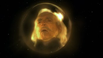 An old man with long white hair is in a bubble