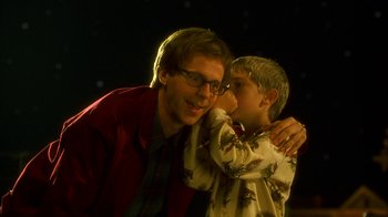 Movie still from “The Master of Disguise” (2002), directed by Perry Andelin Blake – A man and a boy standing next to each other; Close Up shot, Over the shoulder angle