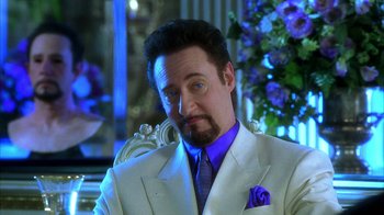 Movie still from “The Master of Disguise” (2002), directed by Perry Andelin Blake – A person wearing a suit and tie; Close Up shot, Low angle
