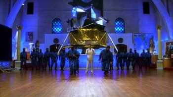 Movie still from “The Master of Disguise” (2002), directed by Perry Andelin Blake – A group of men standing in front of a building; Extreme Wide shot, Low angle