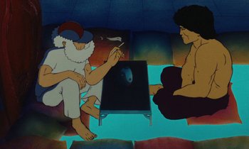 Movie still from “The Masters of Time” (1982), directed by René Laloux – Two men sitting on the ground in front of a table; Medium shot, Low angle