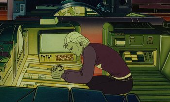 Movie still from “The Masters of Time” (1982), directed by René Laloux – An animated man sitting in front of computer monitors; Medium shot, High angle