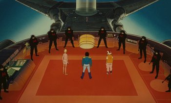 Movie still from “The Masters of Time” (1982), directed by René Laloux – A group of people standing on a red floor in front of a building; Extreme Wide shot, Low angle