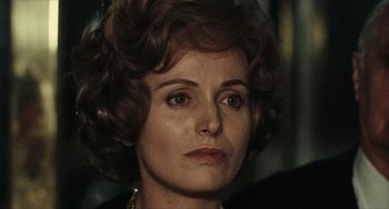 Movie still from “The Mattei Affair” (1972), directed by Francesco Rosi – A woman's face in a dark room; Close Up shot, Over the shoulder angle