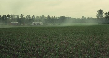 Movie still from “The Mattei Affair” (1972), directed by Francesco Rosi – An open field with a house in the background; Extreme Wide shot, High angle