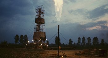 Movie still from “The Mattei Affair” (1972), directed by Francesco Rosi – An old radio tower is in the middle of a field; Extreme Wide shot, Low angle
