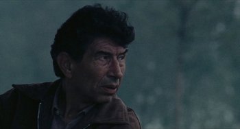 Movie still from “The Mattei Affair” (1972), directed by Francesco Rosi – A person wearing a brown jacket; Close Up shot, Over the shoulder angle