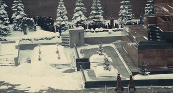 Movie still from “The Mattei Affair” (1972), directed by Francesco Rosi – A group of people standing in the snow near trees; Extreme Wide shot, High angle