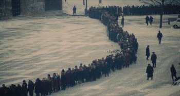 Movie still from “The Mattei Affair” (1972), directed by Francesco Rosi – A large group of people are lined up in a line; Extreme Wide shot, High angle