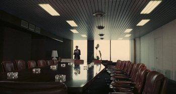 Movie still from “The Mattei Affair” (1972), directed by Francesco Rosi – A man standing in front of a long table; Extreme Wide shot, High angle