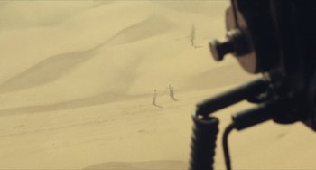 Movie still from “The Mattei Affair” (1972), directed by Francesco Rosi – Two people standing in the sand on a beach; Extreme Wide shot, High angle