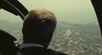 Movie still from “The Mattei Affair” (1972), directed by Francesco Rosi – A man in a suit looking out the window of an airplane; Medium shot, High angle