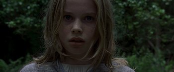 Movie still from “The Messenger: The Story of Joan of Arc” (1999), directed by Luc Besson – A child with long blonde hair; Close Up shot, Low angle