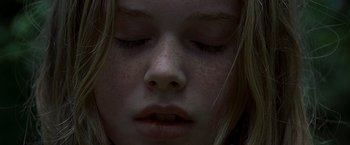 Movie still from “The Messenger: The Story of Joan of Arc” (1999), directed by Luc Besson – A young girl's face with her eyes closed; Extreme Close Up shot, Overhead angle