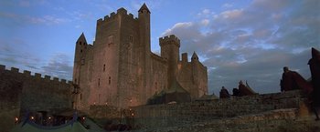 Movie still from “The Messenger: The Story of Joan of Arc” (1999), directed by Luc Besson – An old stone castle with a tent in front of it; Extreme Wide shot, Low angle