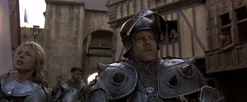 Movie still from “The Messenger: The Story of Joan of Arc” (1999), directed by Luc Besson – A man in a chain mail armor and helmet; Close Up shot, Low angle