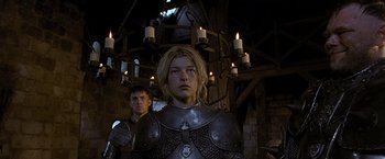 Movie still from “The Messenger: The Story of Joan of Arc” (1999), directed by Luc Besson – A man and a woman dressed in medieval garb in front of candles; Medium shot, Low angle