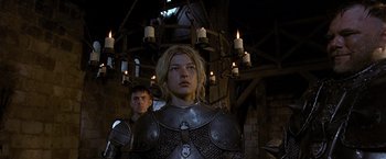 Movie still from “The Messenger: The Story of Joan of Arc” (1999), directed by Luc Besson – A man and a woman dressed in medieval armor; Medium shot, Low angle