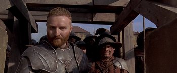 Movie still from “The Messenger: The Story of Joan of Arc” (1999), directed by Luc Besson – A group of men in medieval garb standing next to each other; Close Up shot, Low angle