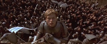 Movie still from “The Messenger: The Story of Joan of Arc” (1999), directed by Luc Besson – A bunch of people are in the middle of a field; Medium shot, High angle
