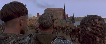Movie still from “The Messenger: The Story of Joan of Arc” (1999), directed by Luc Besson – A crowd of people are gathered in a field; Wide shot, Low angle