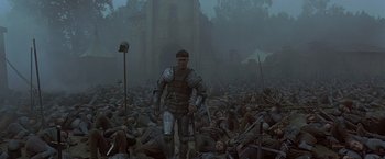 Movie still from “The Messenger: The Story of Joan of Arc” (1999), directed by Luc Besson – A man in armor walking through a crowd of soldiers; Wide shot, High angle