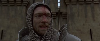 Movie still from “The Messenger: The Story of Joan of Arc” (1999), directed by Luc Besson – A person wearing a chain mail hood; Close Up shot, Low angle