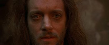 Movie still from “The Messenger: The Story of Joan of Arc” (1999), directed by Luc Besson – A man's face with long brown hair; Close Up shot, High angle