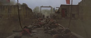 Movie still from “The Messenger: The Story of Joan of Arc” (1999), directed by Luc Besson – A group of people laying down on the ground; Extreme Wide shot, High angle