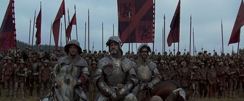 Movie still from “The Messenger: The Story of Joan of Arc” (1999), directed by Luc Besson – A group of men in medieval armor with flags; Wide shot, High angle