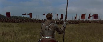 Movie still from “The Messenger: The Story of Joan of Arc” (1999), directed by Luc Besson – A man on a horse in front of a group of soldiers; Wide shot, Low angle