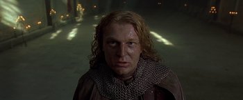 Movie still from “The Messenger: The Story of Joan of Arc” (1999), directed by Luc Besson – A person wearing a chain mail collar; Close Up shot, Low angle