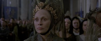 Movie still from “The Messenger: The Story of Joan of Arc” (1999), directed by Luc Besson – A person wearing a headpiece; Close Up shot, Over the shoulder angle