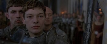 Movie still from “The Messenger: The Story of Joan of Arc” (1999), directed by Luc Besson – A group of people standing next to each other in a room; Close Up shot, Low angle