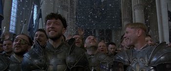Movie still from “The Messenger: The Story of Joan of Arc” (1999), directed by Luc Besson – A group of men in medieval garb standing next to each other in the snow; Close Up shot, Low angle
