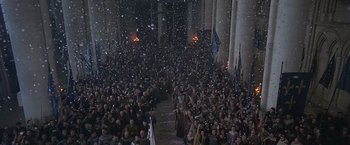 Movie still from “The Messenger: The Story of Joan of Arc” (1999), directed by Luc Besson – A crowd of people standing in the snow at night; Extreme Wide shot, High angle