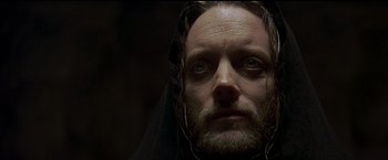 Movie still from “The Messenger: The Story of Joan of Arc” (1999), directed by Luc Besson – A person with a beard wearing a veil; Close Up shot, Low angle